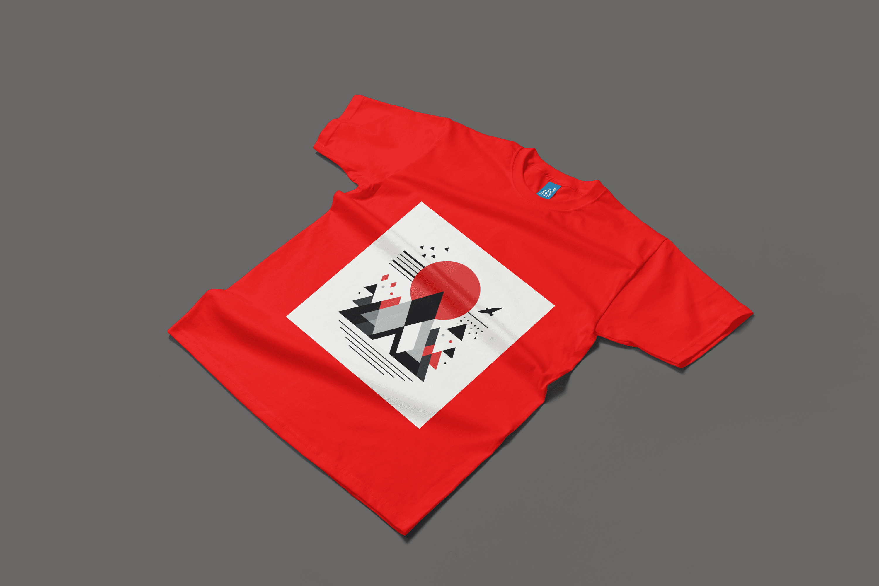 A bright red t-shirt displaying a red triangle and mountain motifon a white vinyl print, combining minimalist design with an adventurous spirit.